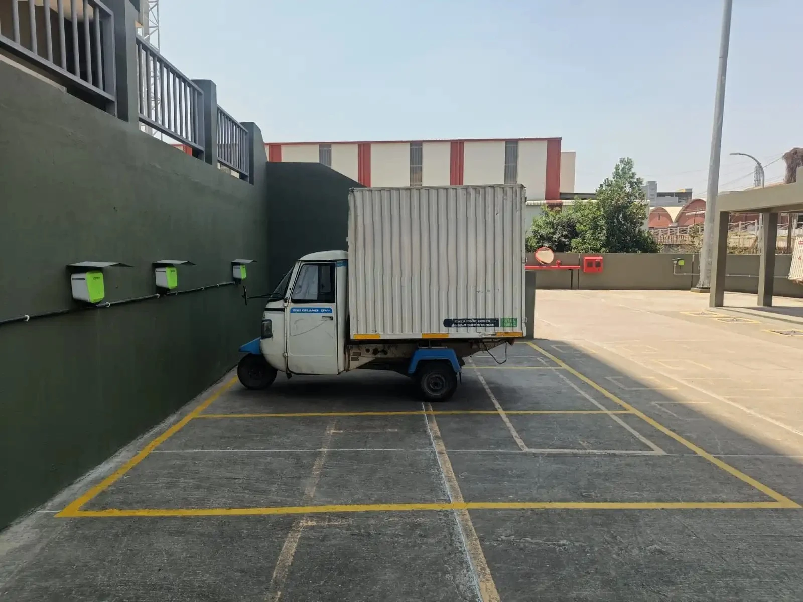 Electric cargo vehicle charging at commercial EV charging station in a dedicated fleet parking area