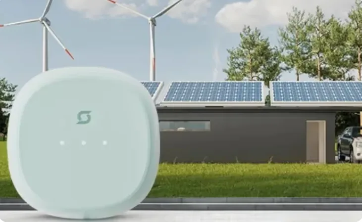 Smart EV charger device placed in front of a home with rooftop solar panels and wind turbines in the background.